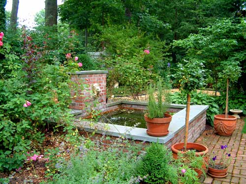 formal pond with fountain and brick walkways