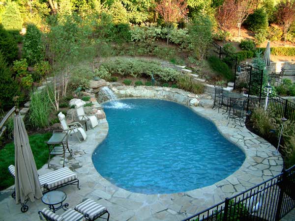Natural swimming pool with stone pool decking.